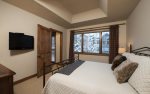 Jr. master suite with king bed, flat screen TV, and en-suite bathroom